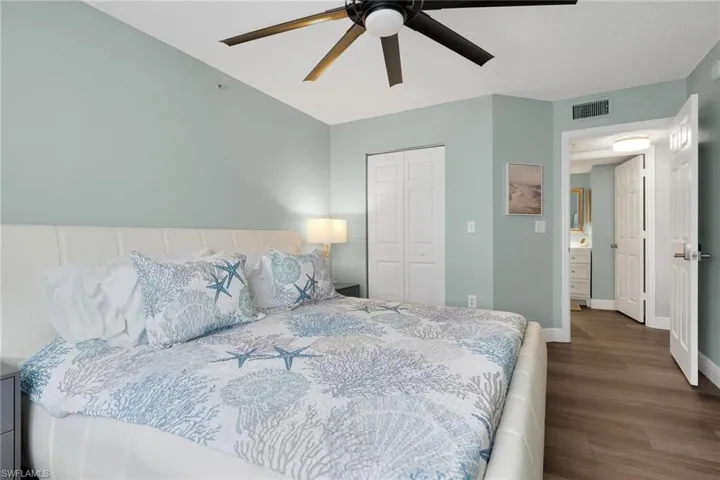 Bedroom featuring a closet, dark wood finished floors, and ceiling fan