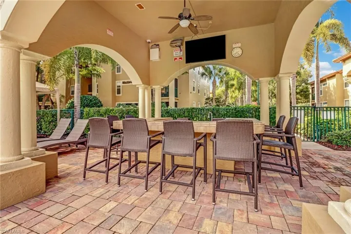 View of patio / terrace with ceiling fan and an outdoor bar