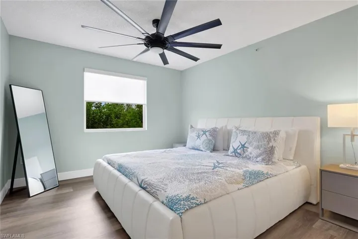 Bedroom with wood finished floors and a ceiling fan