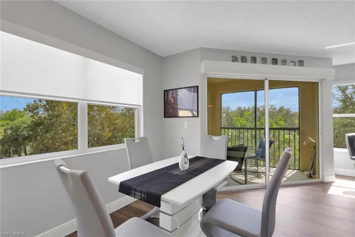 Dining area featuring wood finished floors and a textured ceiling