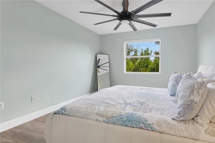 Bedroom featuring wood finished floors and a ceiling fan