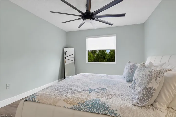 Bedroom with wood finished floors and a ceiling fan