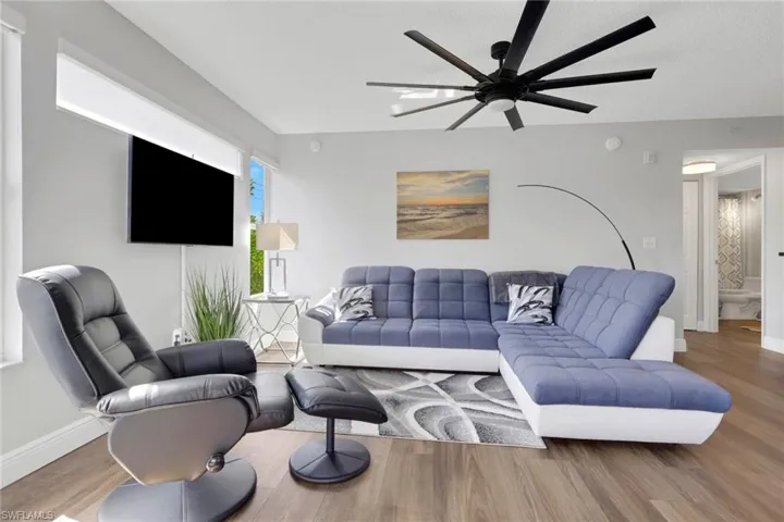 Living area featuring wood finished floors and ceiling fan