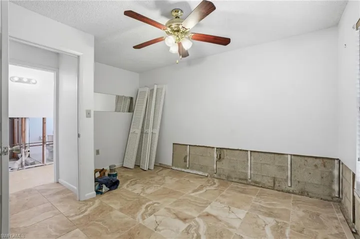 Spare room featuring a textured ceiling and ceiling fan