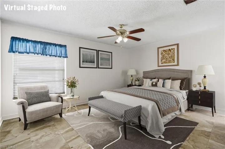 Bedroom featuring ceiling fan and a textured ceiling