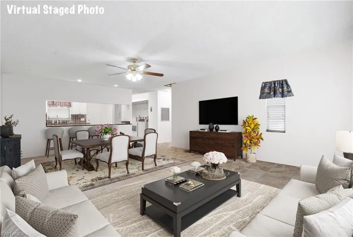 Living area featuring ceiling fan and healthy amount of natural light