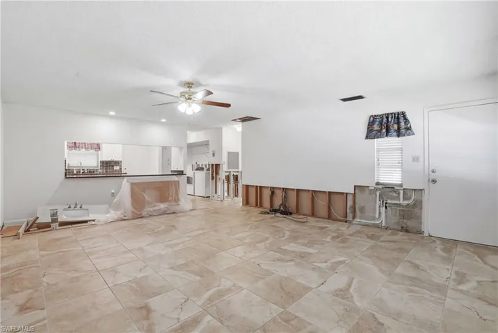 Unfurnished living room featuring ceiling fan and recessed lighting