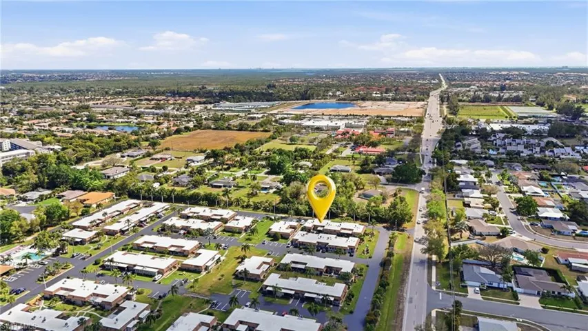 Aerial perspective of suburban area featuring a large body of water
