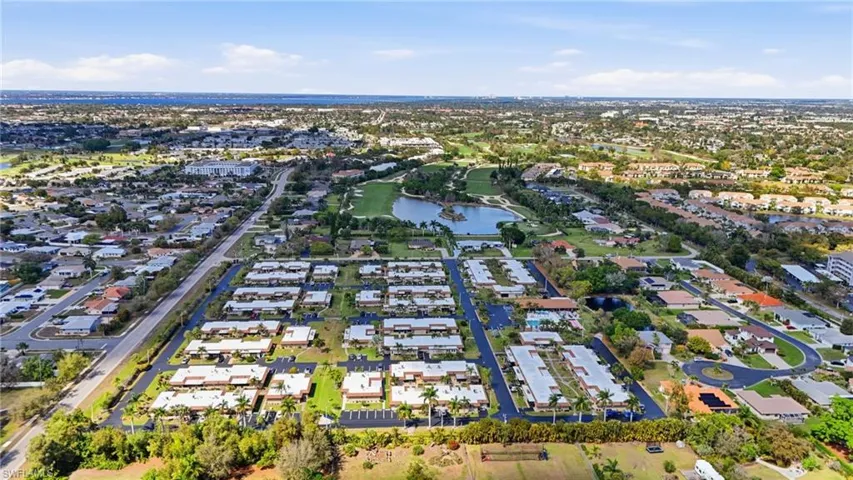 Aerial view of residential area featuring a large body of water