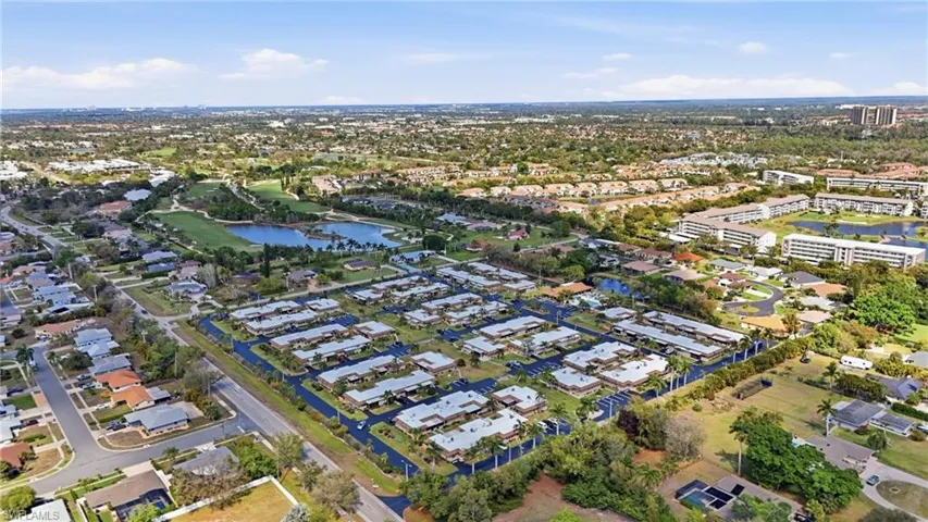 Aerial perspective of suburban area featuring a large body of water