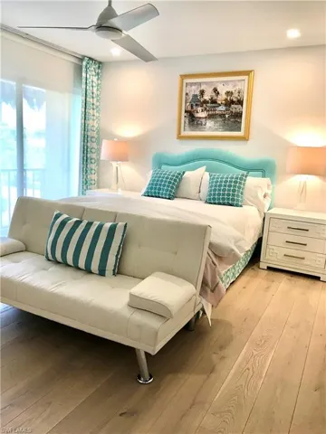 Bedroom featuring light wood finished floors, a ceiling fan, and recessed lighting