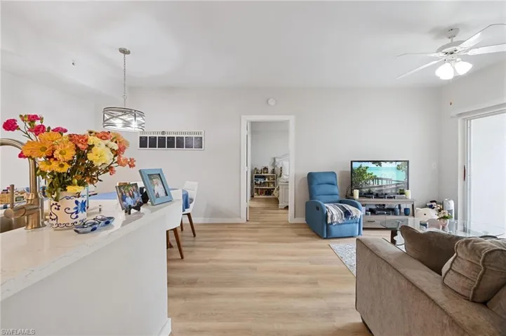 Living area with light wood-style flooring and ceiling fan