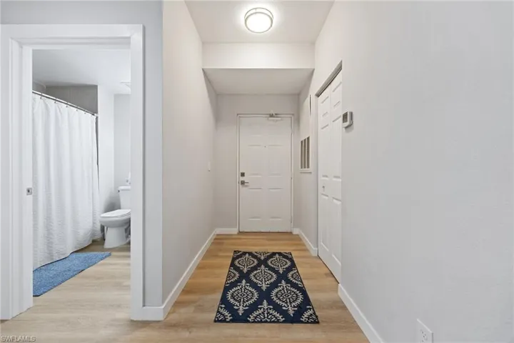 Hallway featuring baseboards and light wood-type flooring