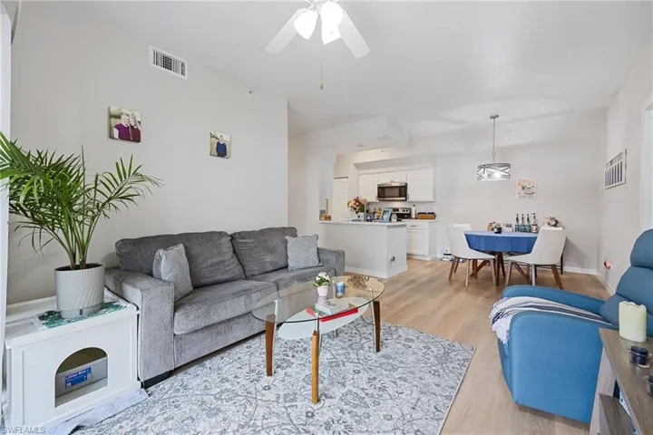 Living room featuring light wood-style flooring and ceiling fan