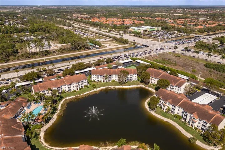 Aerial view of property and surrounding area featuring a large body of water
