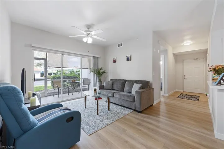 Living area with light wood-type flooring and ceiling fan