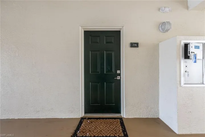 Property entrance with stucco siding