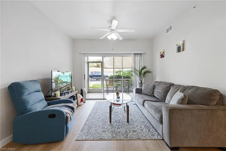 Living area with light wood-style flooring and ceiling fan