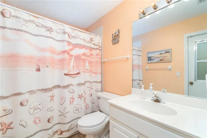 Full bathroom featuring vanity and curtained shower