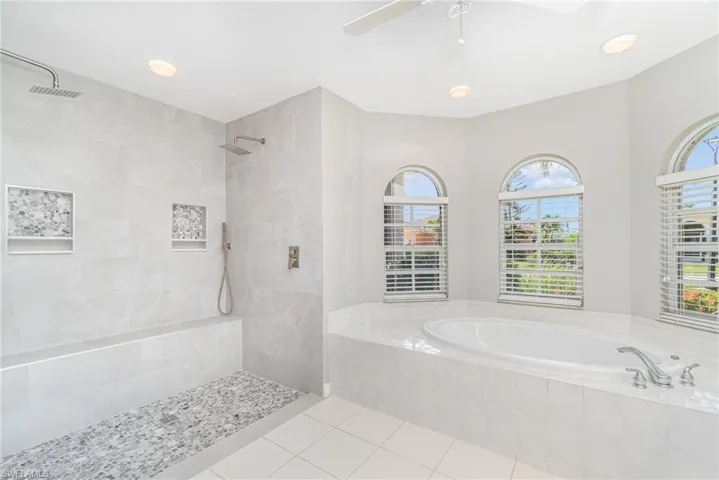 Bathroom featuring tiled shower, a garden tub, tile patterned flooring, recessed lighting, and ceiling fan