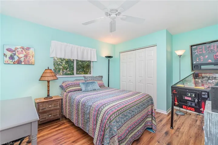 Bedroom featuring wood finished floors, a ceiling fan, and a closet