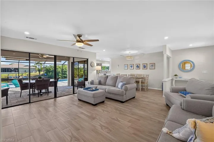 Open-concept living space featuring tile flooring and recessed lighting