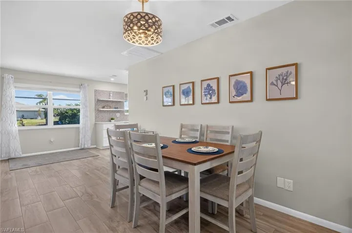 Open concept dining space with plank finish tile flooring