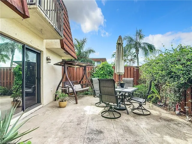 View of patio with a fenced courtyard and outdoor dining area