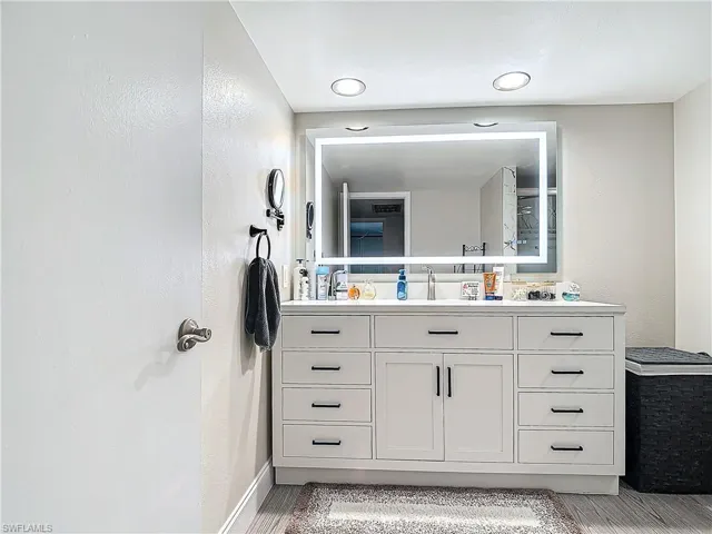 Bathroom featuring a smart LED anti-fog mirror