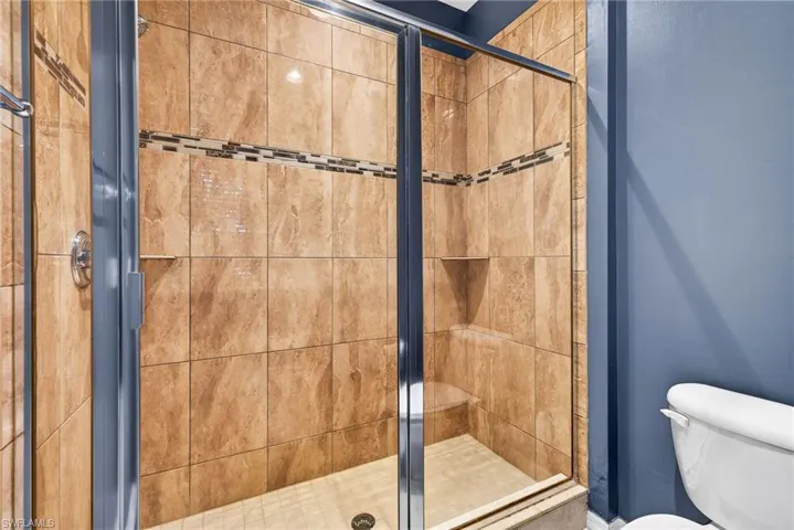 Bathroom with a stall shower and toilet