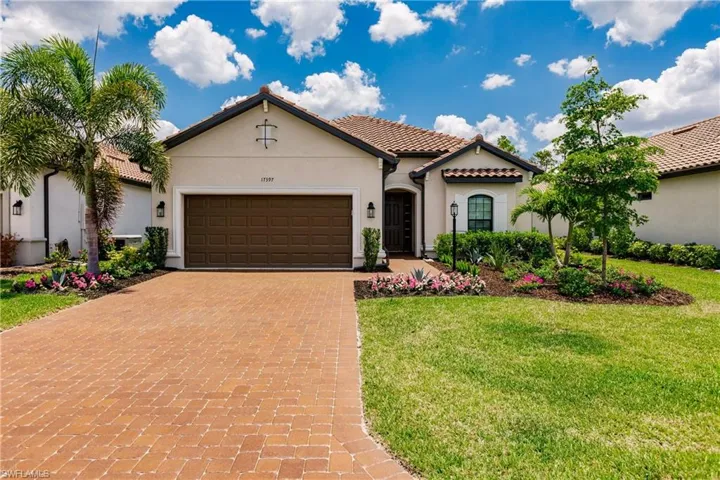 Mediterranean / spanish home featuring a front lawn and a garage