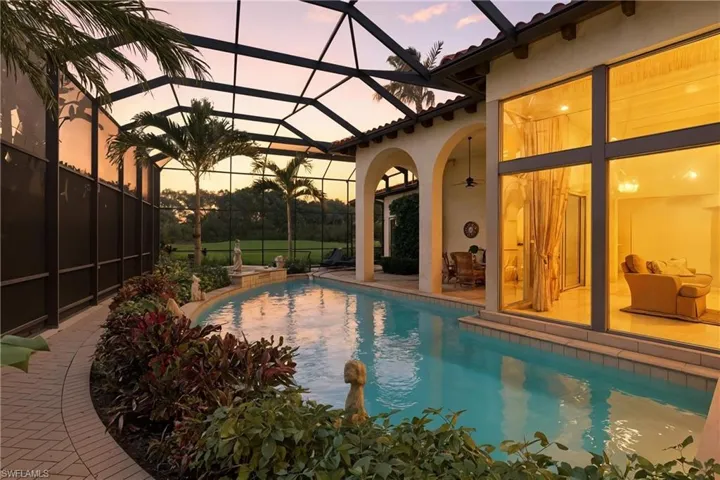 Swimming pool featuring a lanai, a sunroom, and a patio area