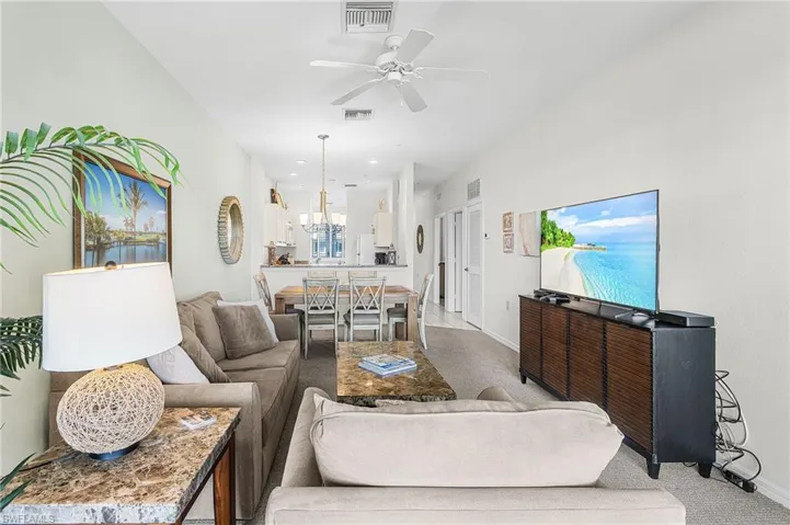 Living area featuring carpet floors, a ceiling fan, and recessed lighting