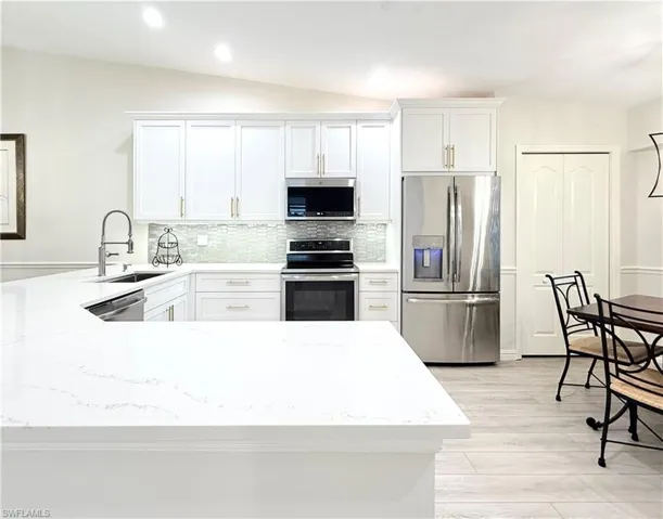 Custom Cabinets, Tile Backsplash, Quartz Countertops and Under Cabinet Lighting