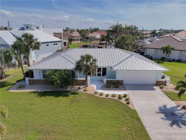 View of front of house with a front yard and a garage