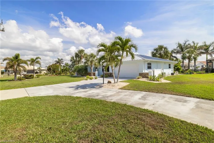 View of front of home with a garage and a front yard