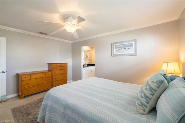 Bedroom featuring ornamental molding, ceiling fan, and light tile patterned floors