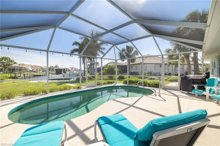 View of pool featuring a lanai, a grill, and a patio area