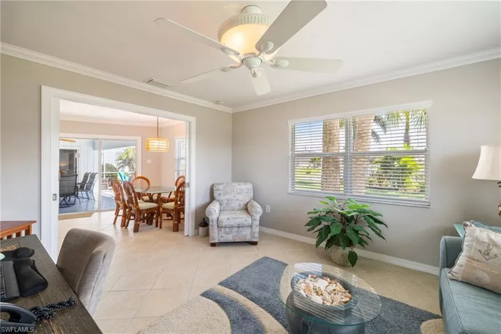 Tiled office with ceiling fan and ornamental molding