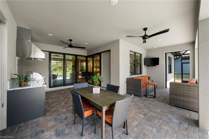 View of patio with an outdoor living space and ceiling fan