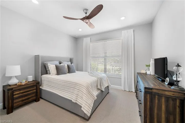 Carpeted bedroom with ceiling fan