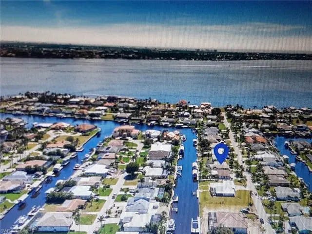 Aerial view of residential area featuring a large body of water