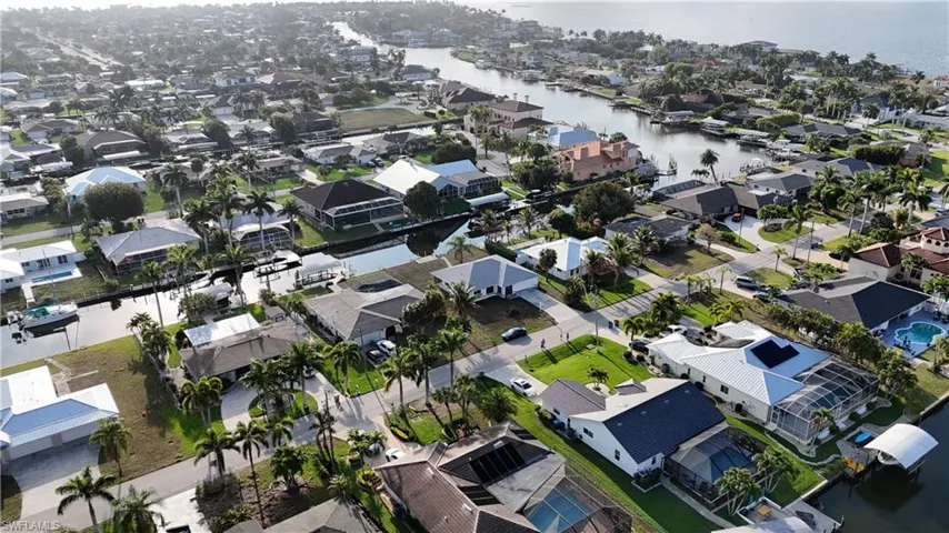 Aerial perspective of suburban area with a nearby body of water