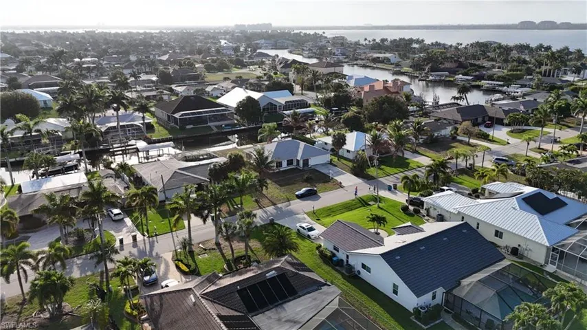 Aerial perspective of suburban area with a nearby body of water
