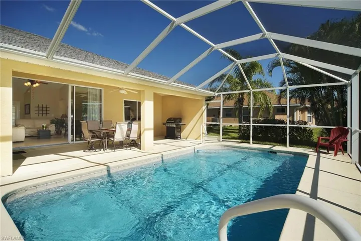 Pool with a patio area, area for grilling, ceiling fan, and a lanai