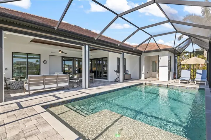 View of outdoor patio and outdoor kitchen that is under cover and perfect for entertaining!