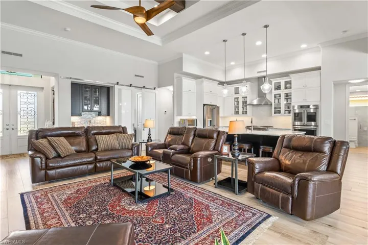 Living area is open to the den, kitchen, dining and the incredible outdoor oasis!