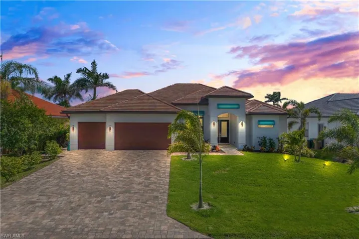CURB APPEAL!  This gorgeous custom home was designed with no stone left unturned!  Paved brick long driveway, lush landscaping, Bahama shutters and all located on a very desirable gulf access lot!