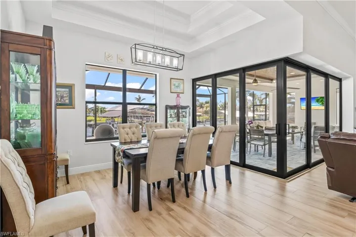 Formal dining room with full views of the outdoors - expansive picture window and open sliders!  This space can hold a ten seat dining table!