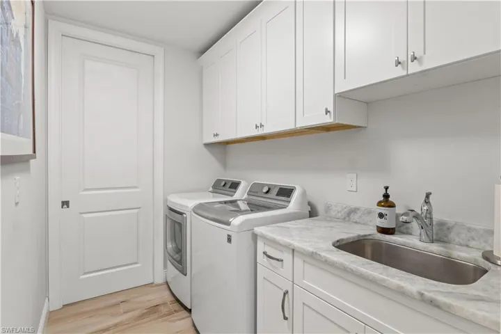 Laundry room with more storage cabinets and a laundry tub!